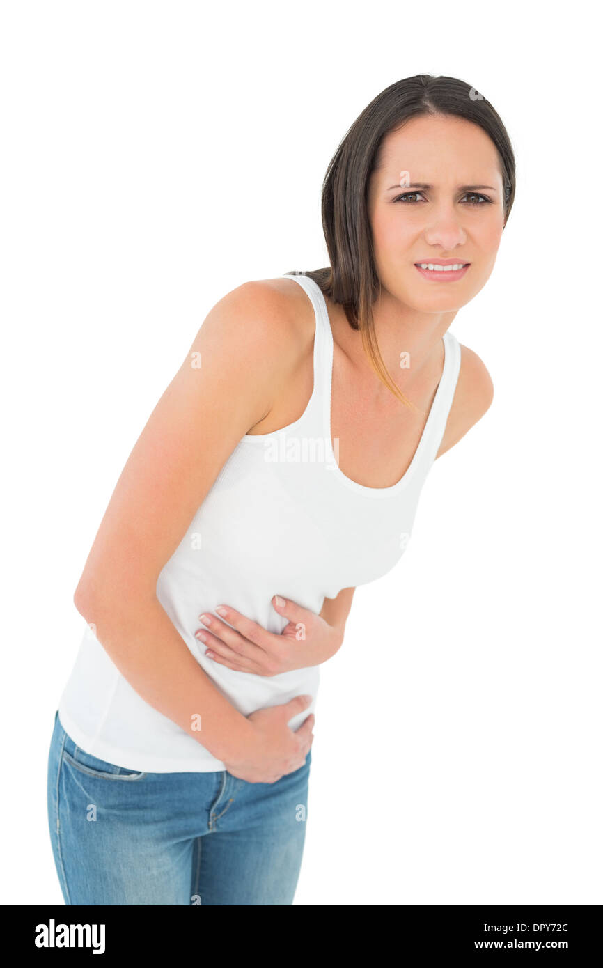 Casual young woman with stomach pain Stock Photo Alamy