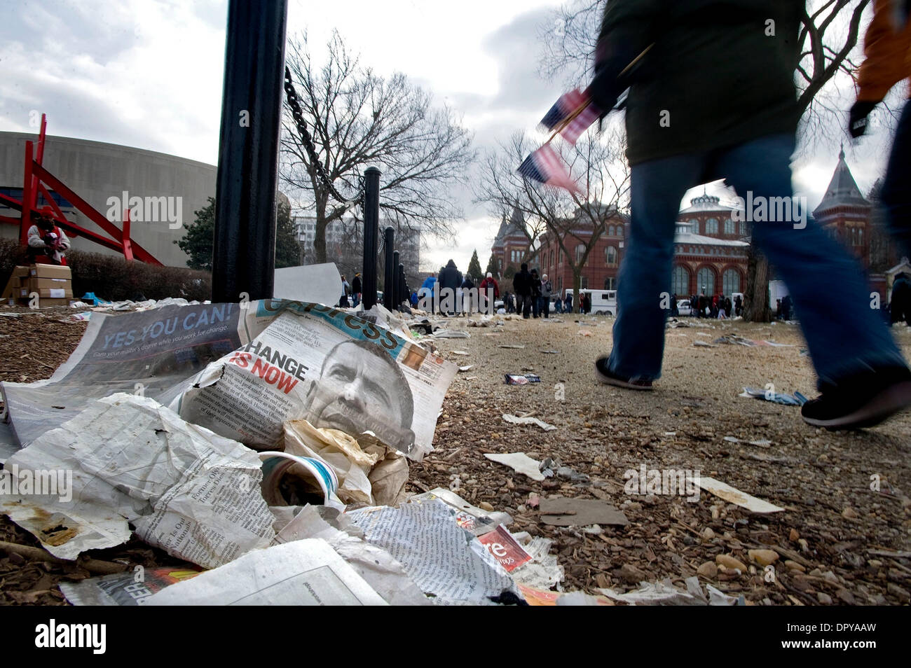Jan 20, 2009 - Washington, District of Columbia, USA - People walk past discarded newspapers as they leave the National Mall following the inauguration of Obama as the 44th President of the United States. (Credit Image: © Pete Marovich/ZUMA Press) Stock Photo