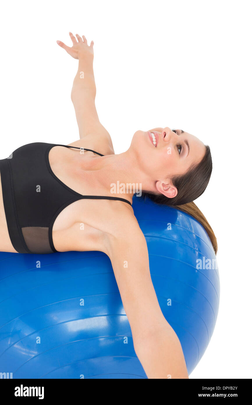 Side view of a fit woman stretching on fitness ball Stock Photo - Alamy