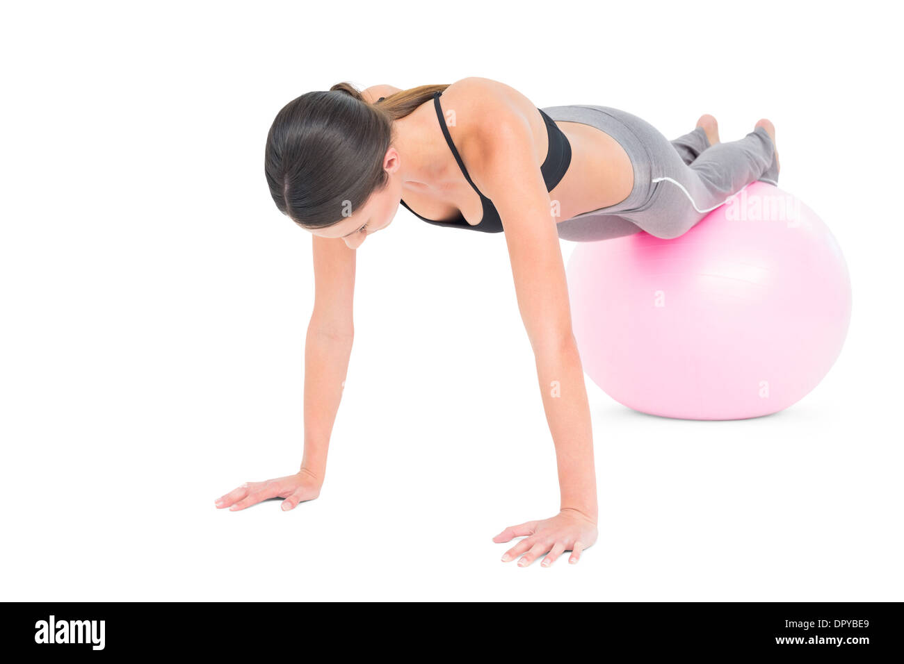 Fit woman doing push ups on fitness ball Stock Photo