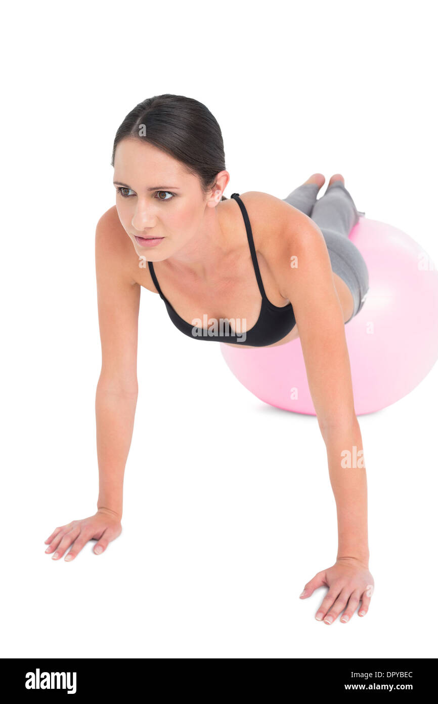 Full length of a fit woman doing push ups on fitness ball Stock Photo