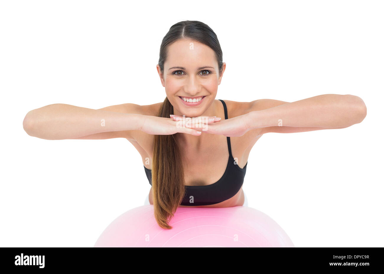 Smiling fit young woman stretching on fitness ball Stock Photo - Alamy