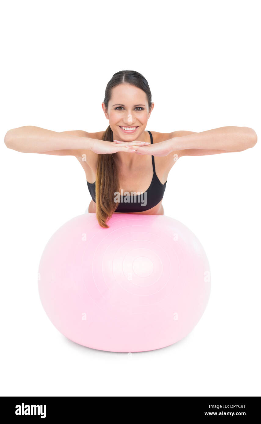 Portrait of a smiling fit woman stretching on fitness ball Stock Photo ...