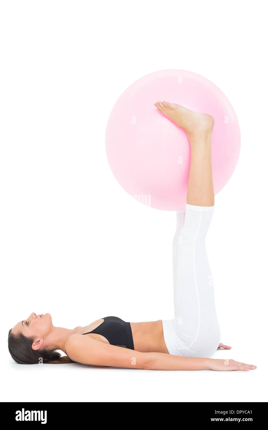 Side view of a fit woman exercising with fitness ball Stock Photo - Alamy
