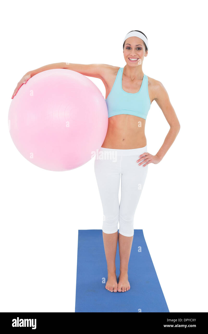Portrait of a smiling fit woman holding fitness ball Stock Photo - Alamy