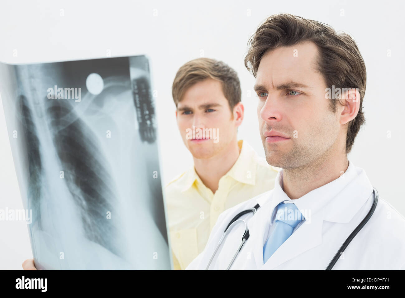 Concentrated doctor and patient examining lungs x-ray Stock Photo