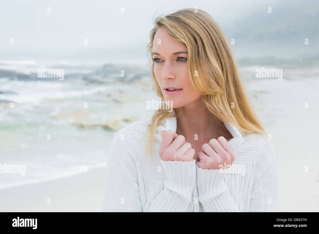 Contemplative casual young woman at beach Stock Photo