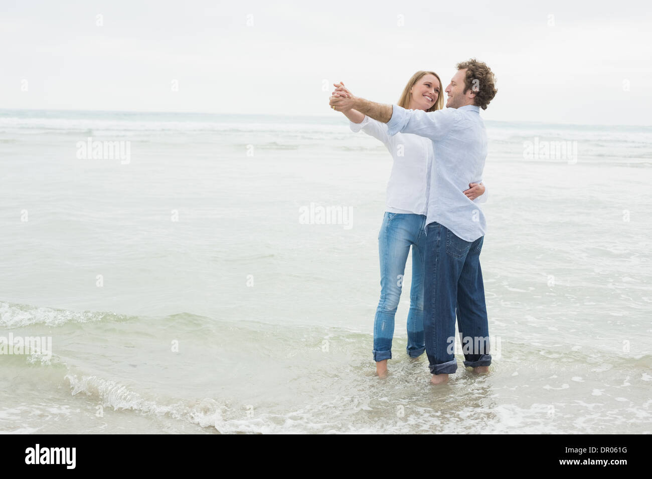 Full length of a couple dancing at beach Stock Photo - Alamy