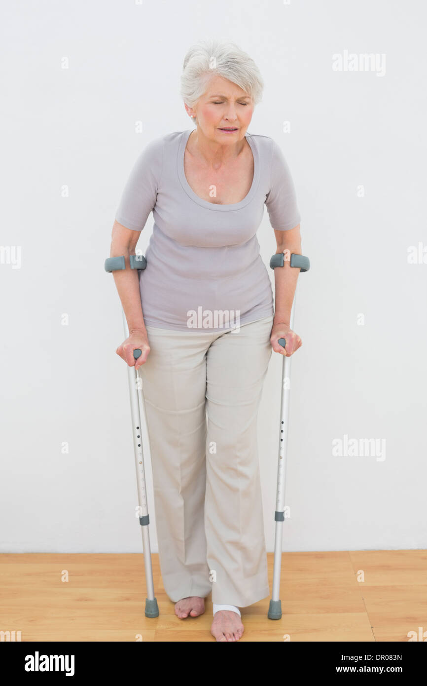 Full length senior woman crutches hires stock photography and images