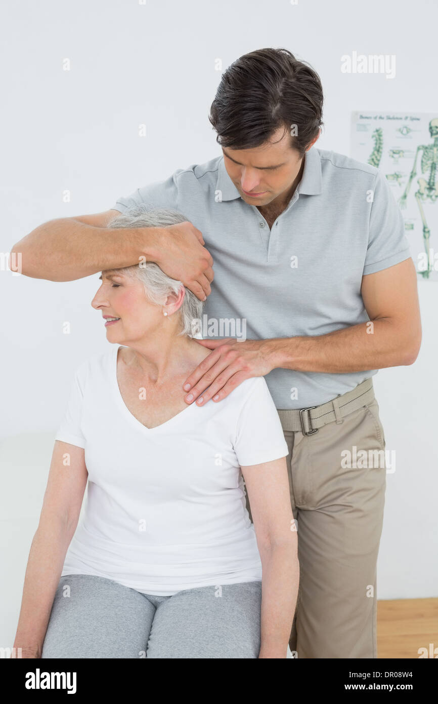 Senior woman getting the neck adjustment done Stock Photo Alamy