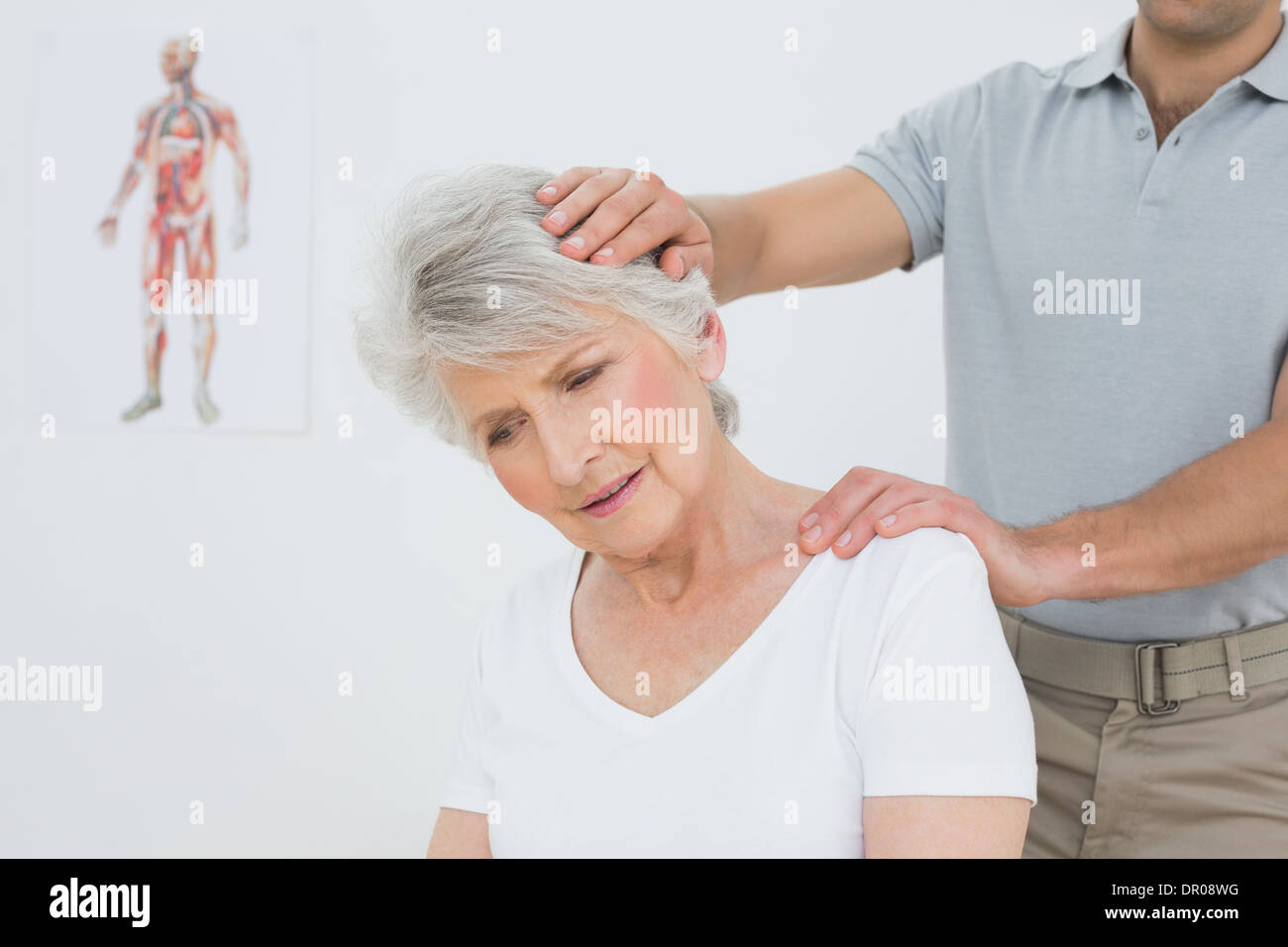 Senior woman getting the neck adjustment done Stock Photo Alamy