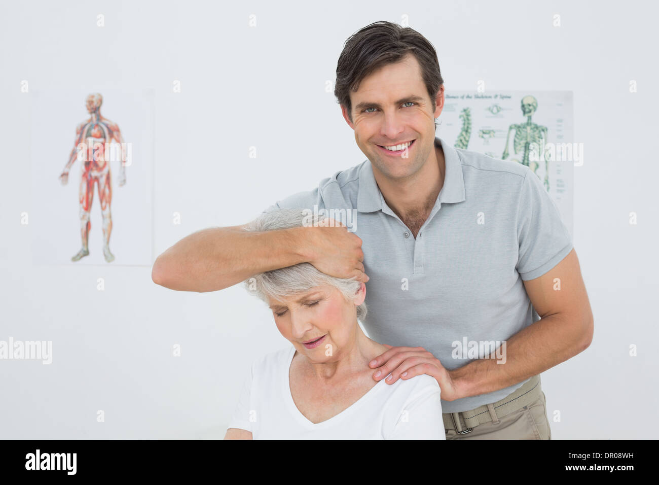 Senior woman getting the neck adjustment done Stock Photo - Alamy