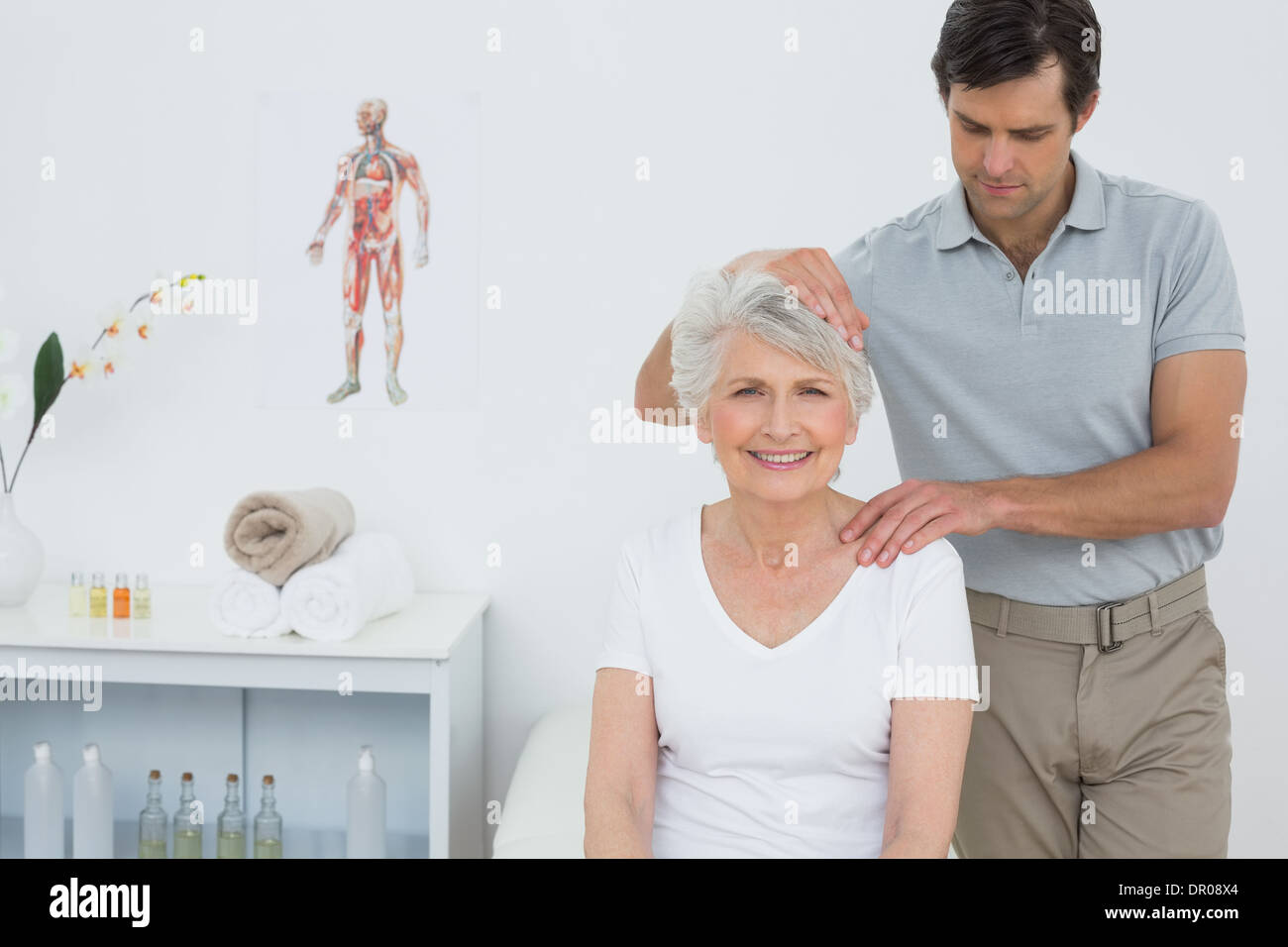 Senior woman getting the neck adjustment done Stock Photo Alamy
