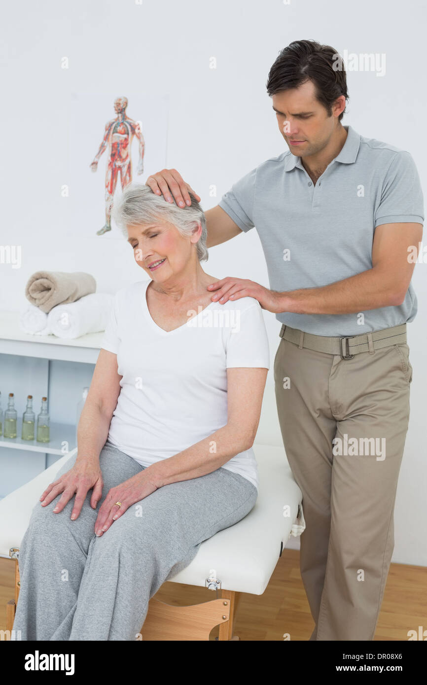 Senior woman getting the neck adjustment done Stock Photo Alamy