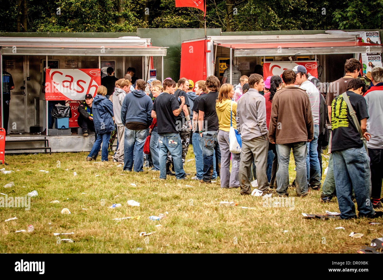 Queue of people at cash machines during music festival Stock Photo