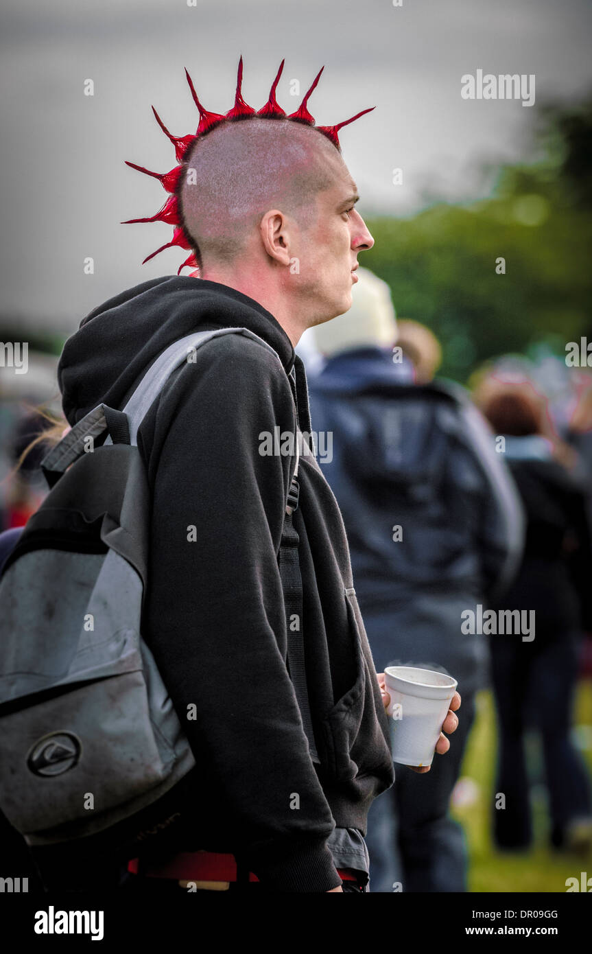 Young caucasian male punk with red mohican at a music festival Stock Photo