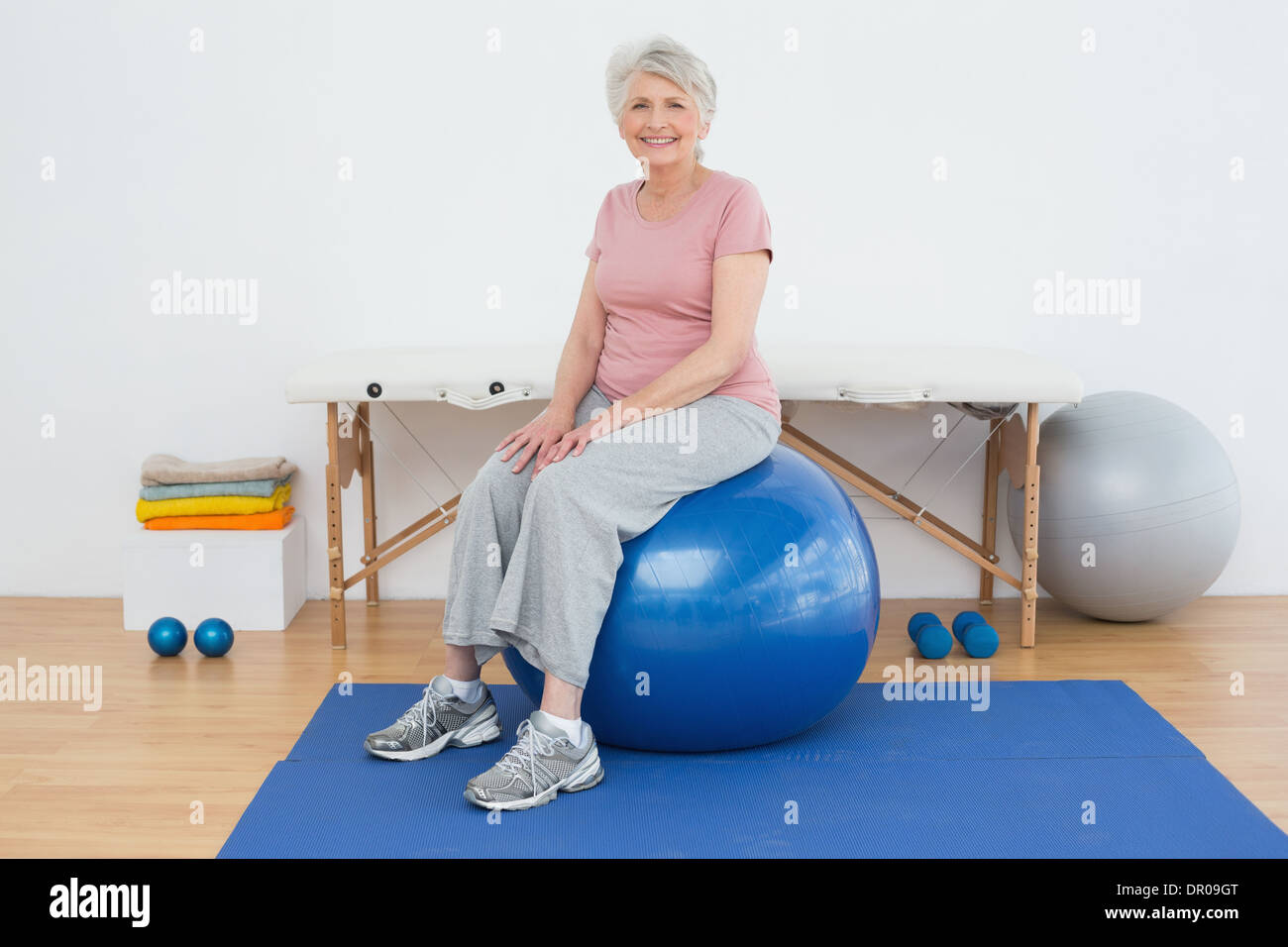Portrait of a senior woman sitting on fitness ball Stock Photo