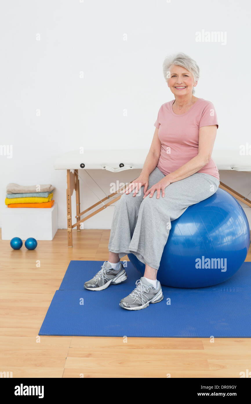Portrait of a senior woman sitting on fitness ball Stock Photo