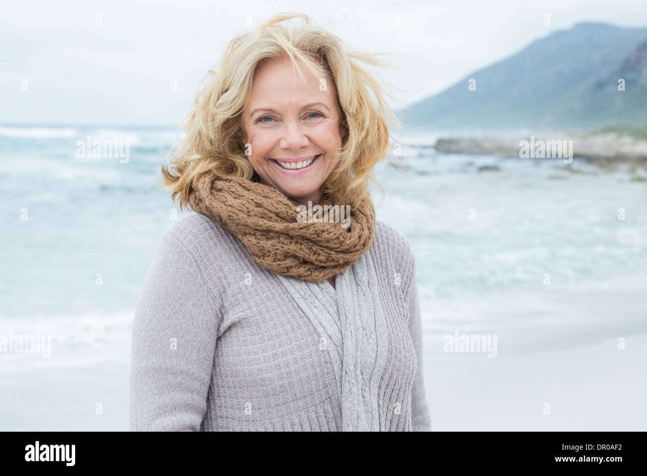 Smiling casual senior woman relaxing at beach Stock Photo - Alamy