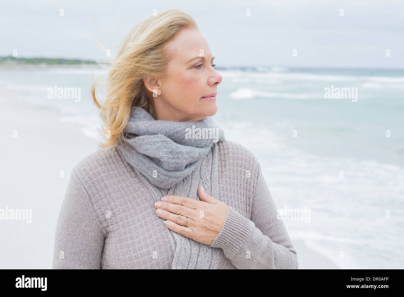 Contemplative casual senior woman at beach Stock Photo