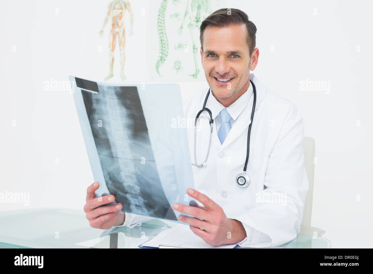 Portrait of a smiling male doctor with x-ray picture Stock Photo