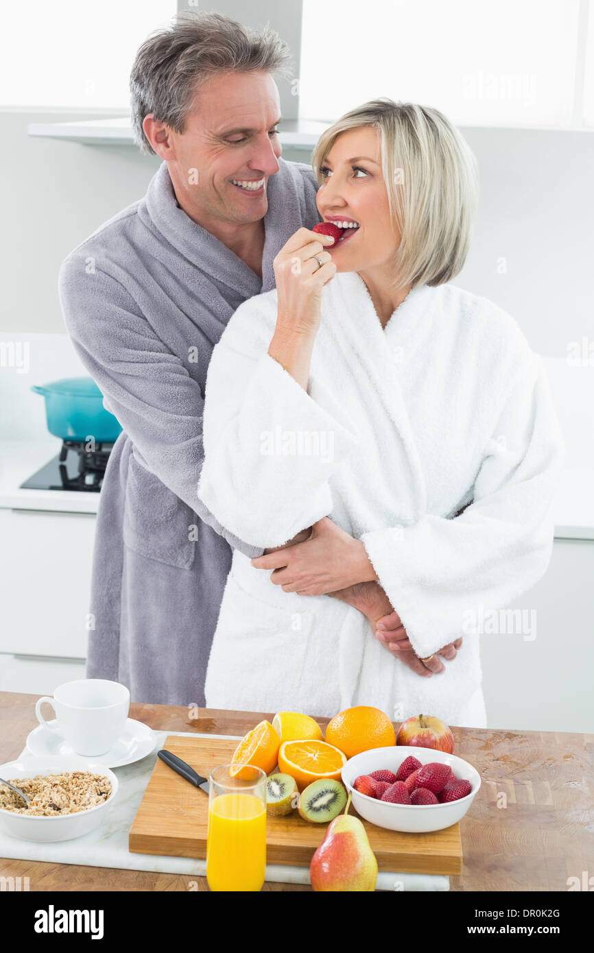 Man embracing a woman from behind in kitchen Stock Photo - Alamy