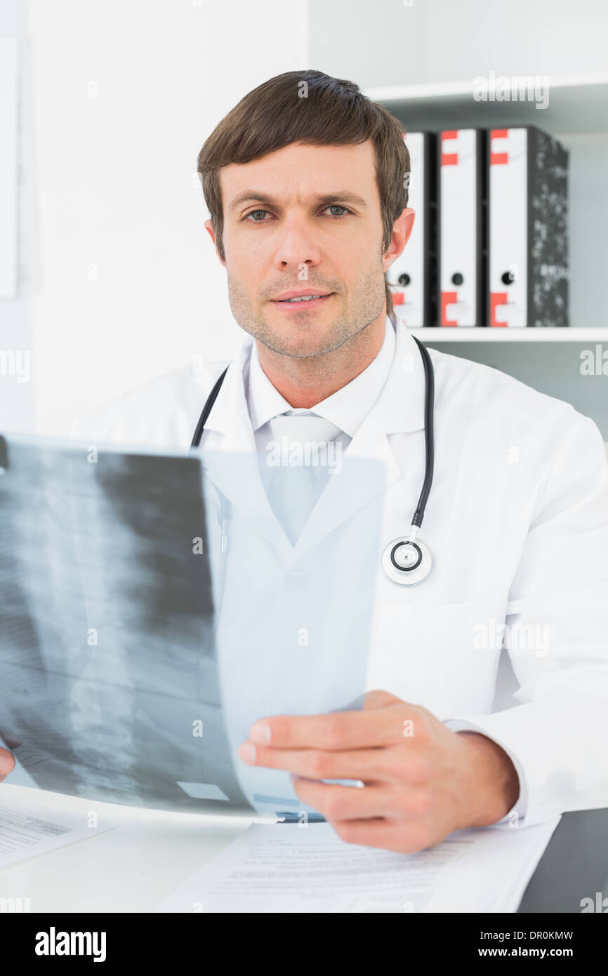 Doctor with x-ray picture of spine in the medical office Stock Photo