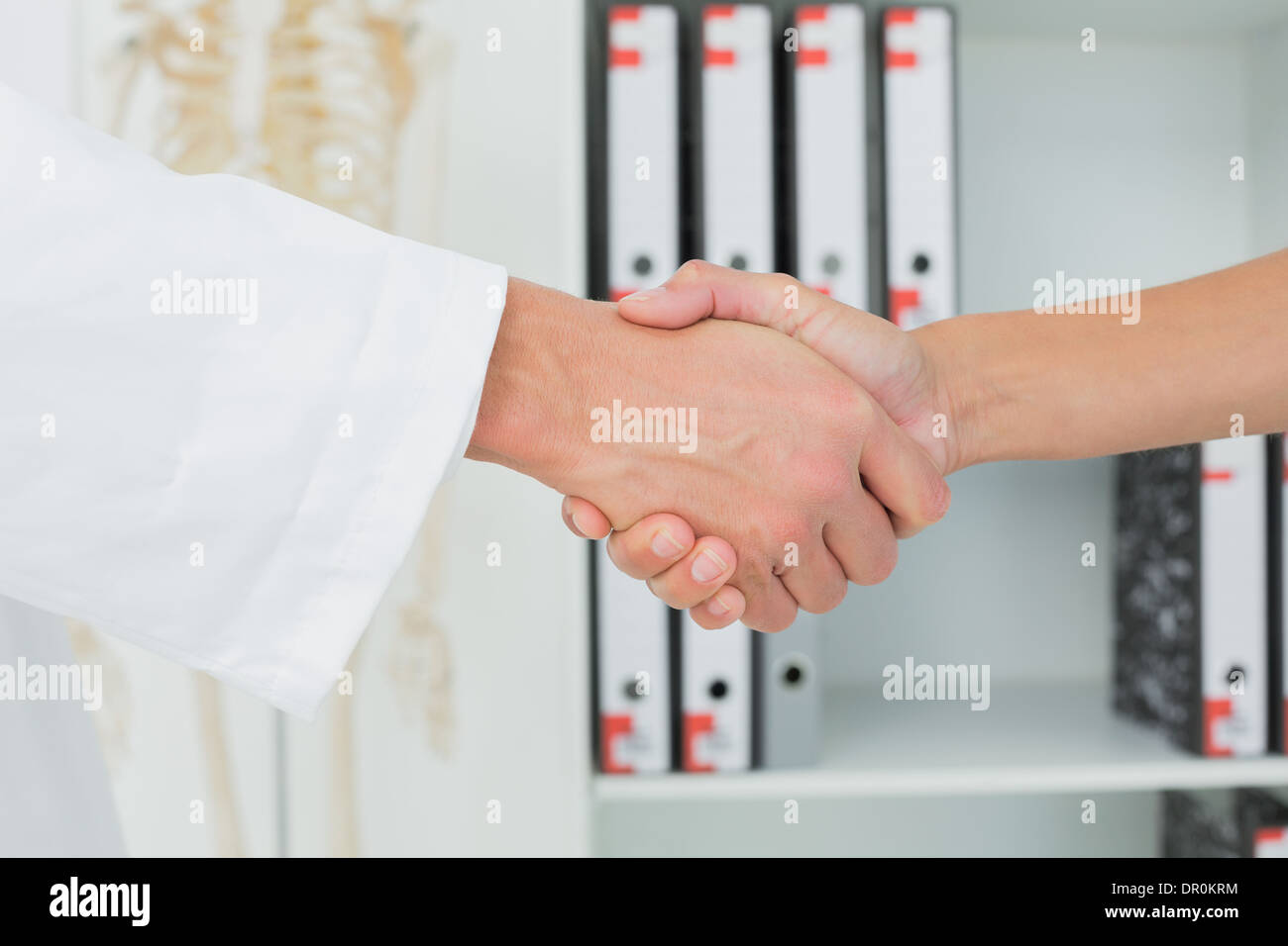 Extreme closeup of a doctor and patient shaking hands Stock Photo