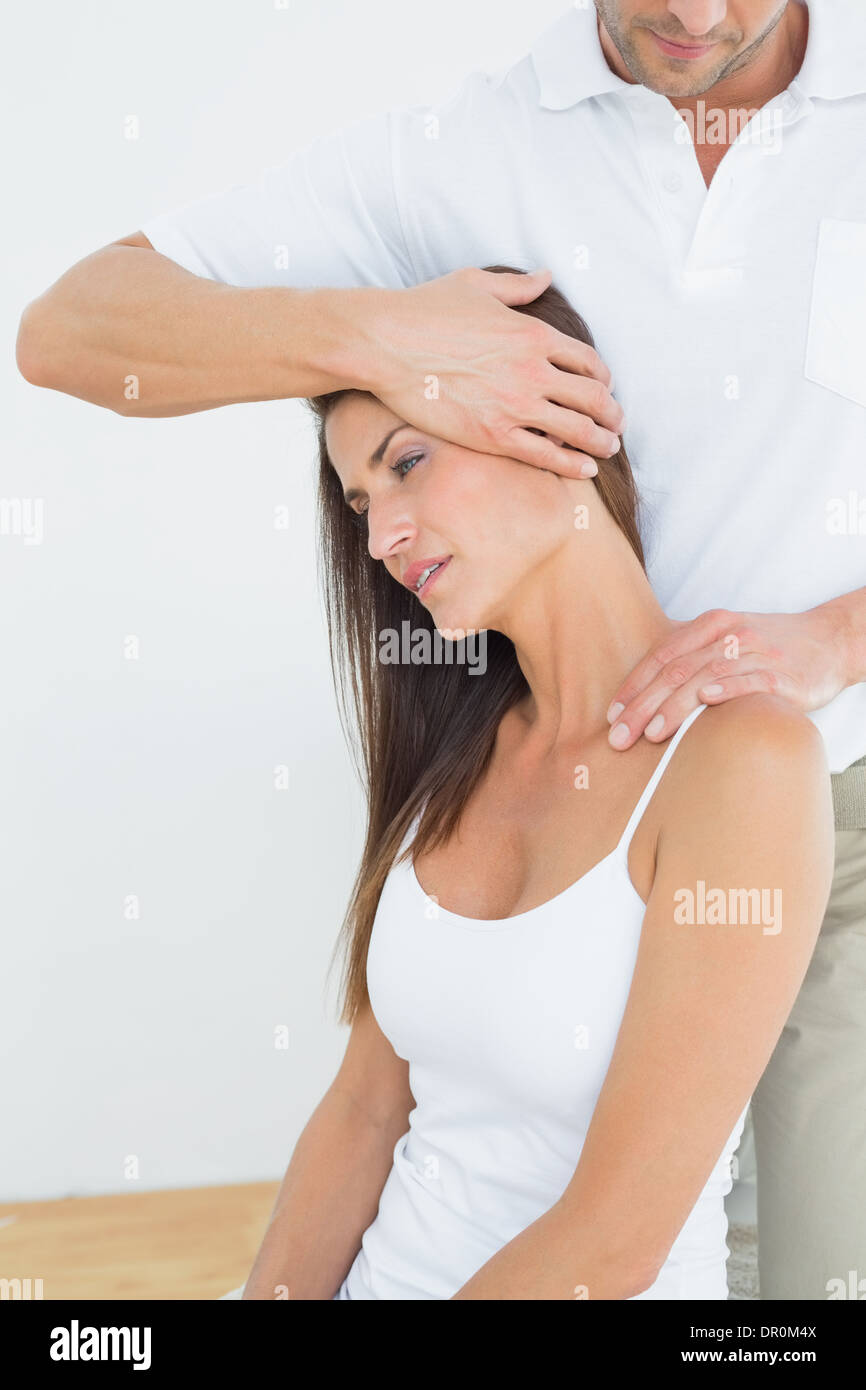 Male chiropractor doing neck adjustment Stock Photo Alamy
