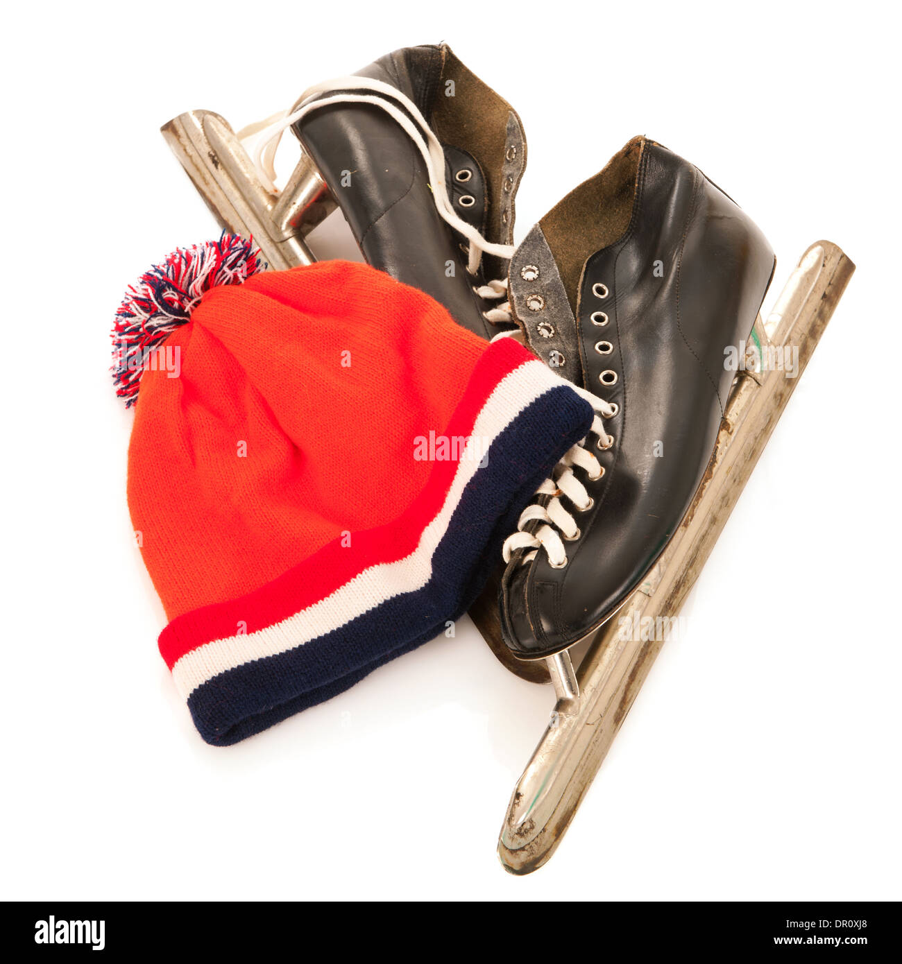 Used male ice skates and orange dutch hat isolated over white background Stock Photo