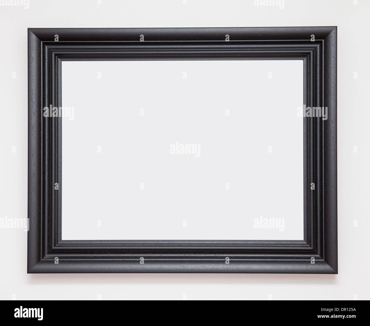 blank black picture frame on white wall Stock Photo