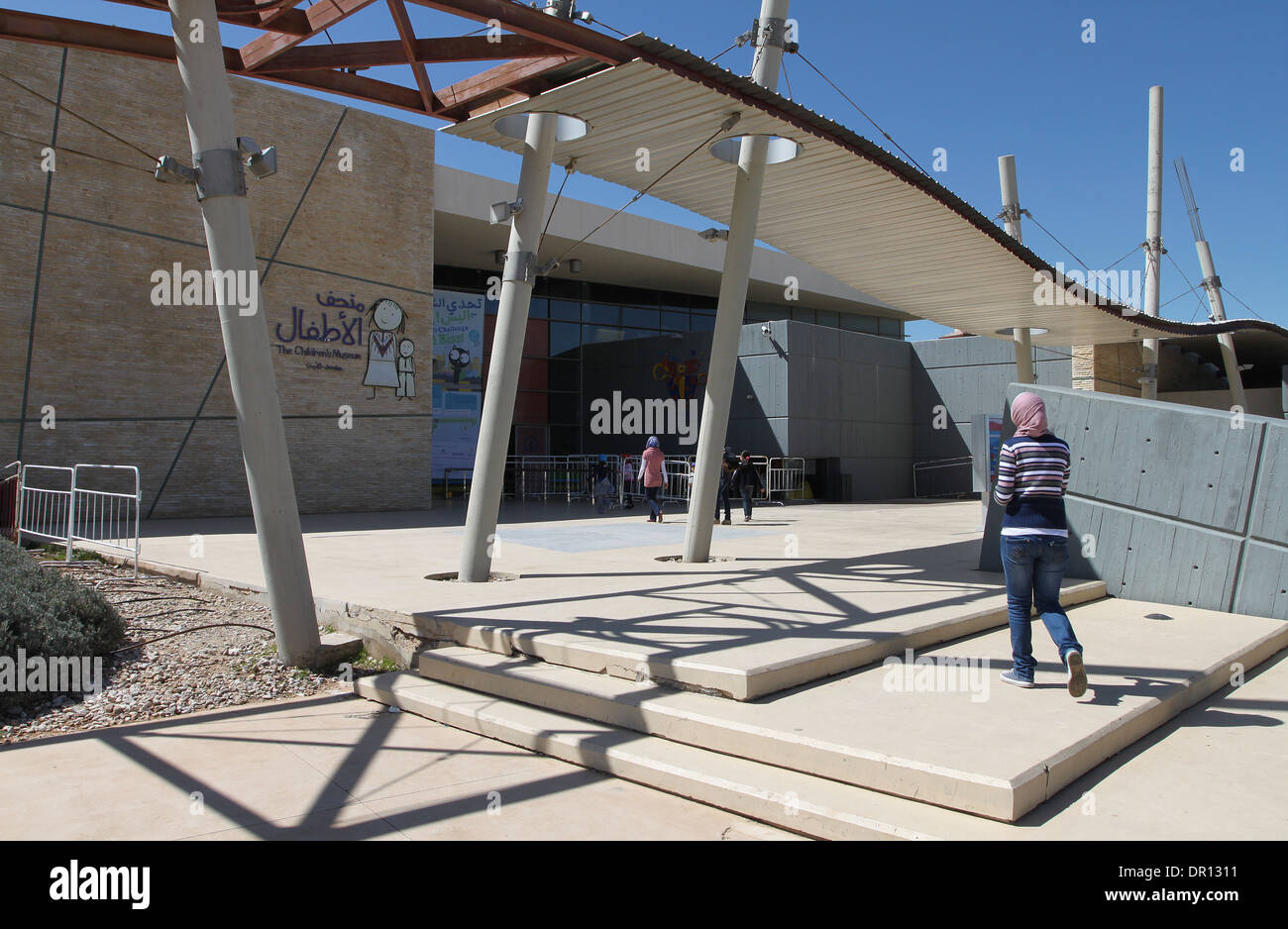 An Arab girl going to the entrance of the Children’s Museum, situated within the Al Hussein National Park in Amman, Jordan. Stock Photo
