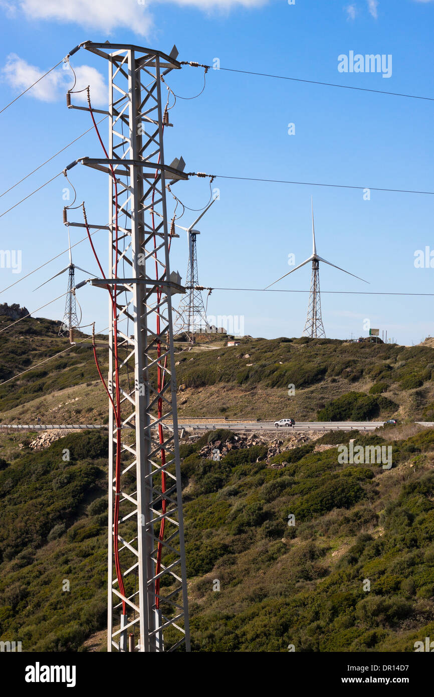 Green hills with electricity poles and wind turbines. Tarifa, Cadiz, Andalusia, Spain. Stock Photo