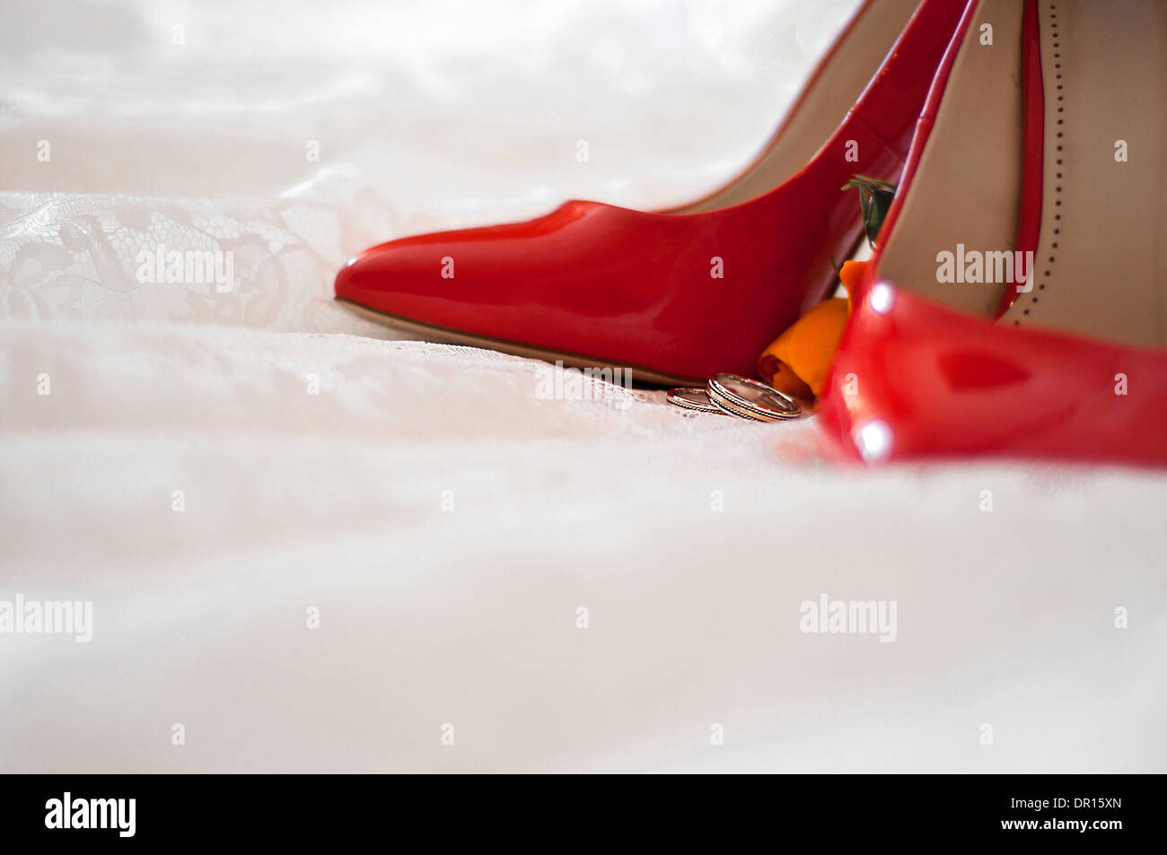 Red Shoes Of The Bride Wedding Rings And Buttonhole On A Wedding