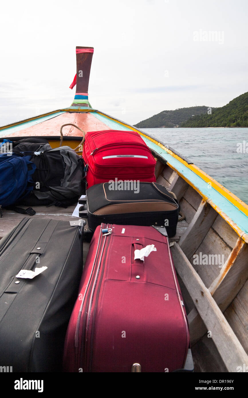 Detail of long tailed boat full of luggage head for Phi Phi Island – Thailand. Stock Photo