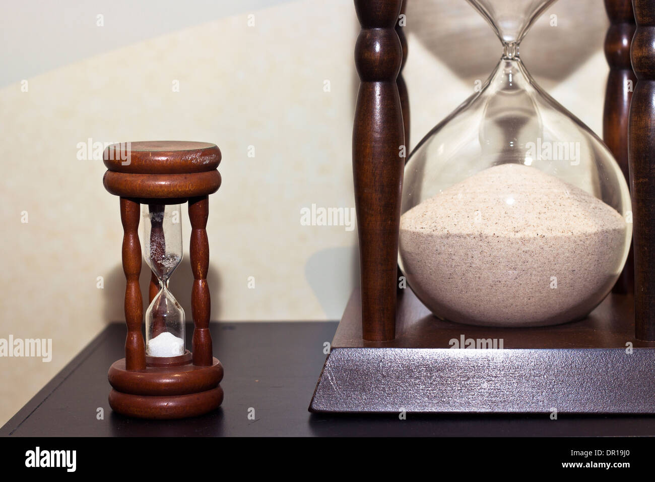 Two old antique wooden sand clock. Big and small sand clock. Stock Photo