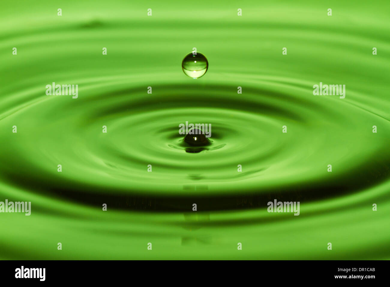Water drop on green background Stock Photo - Alamy