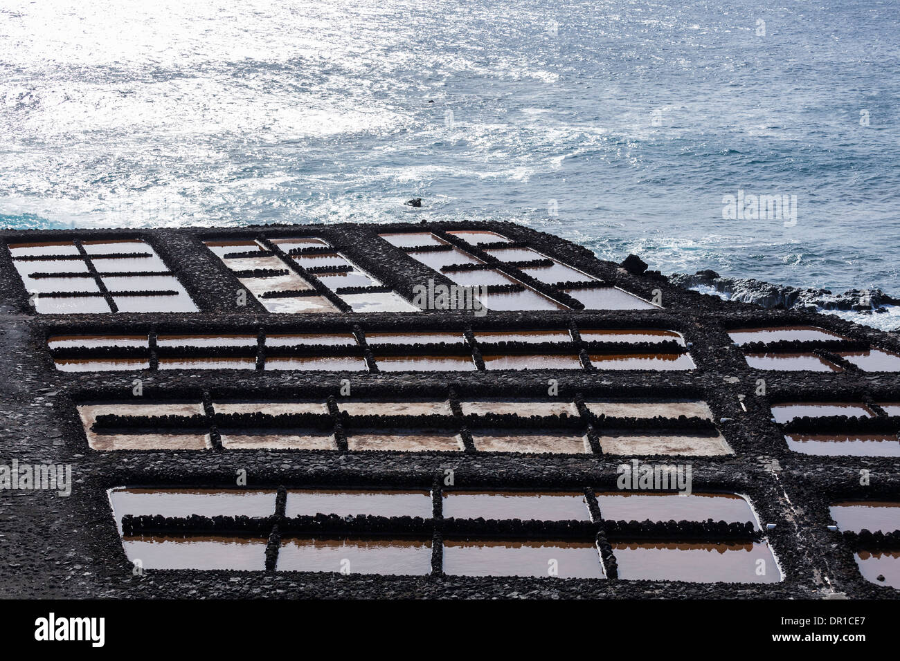 Saltwater ponds where sea salt production is carried out through desalination at Fuencaliente, La Palma, Canary Islands, Spain, Stock Photo