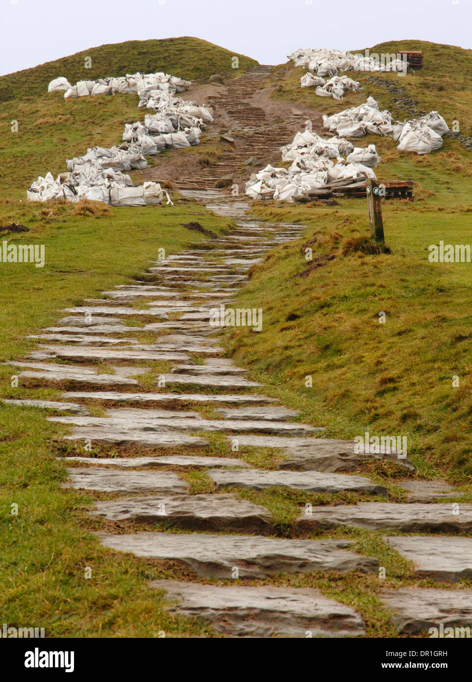 Repair of eroded stone footpath in progress on Mam Tor, a popular ...