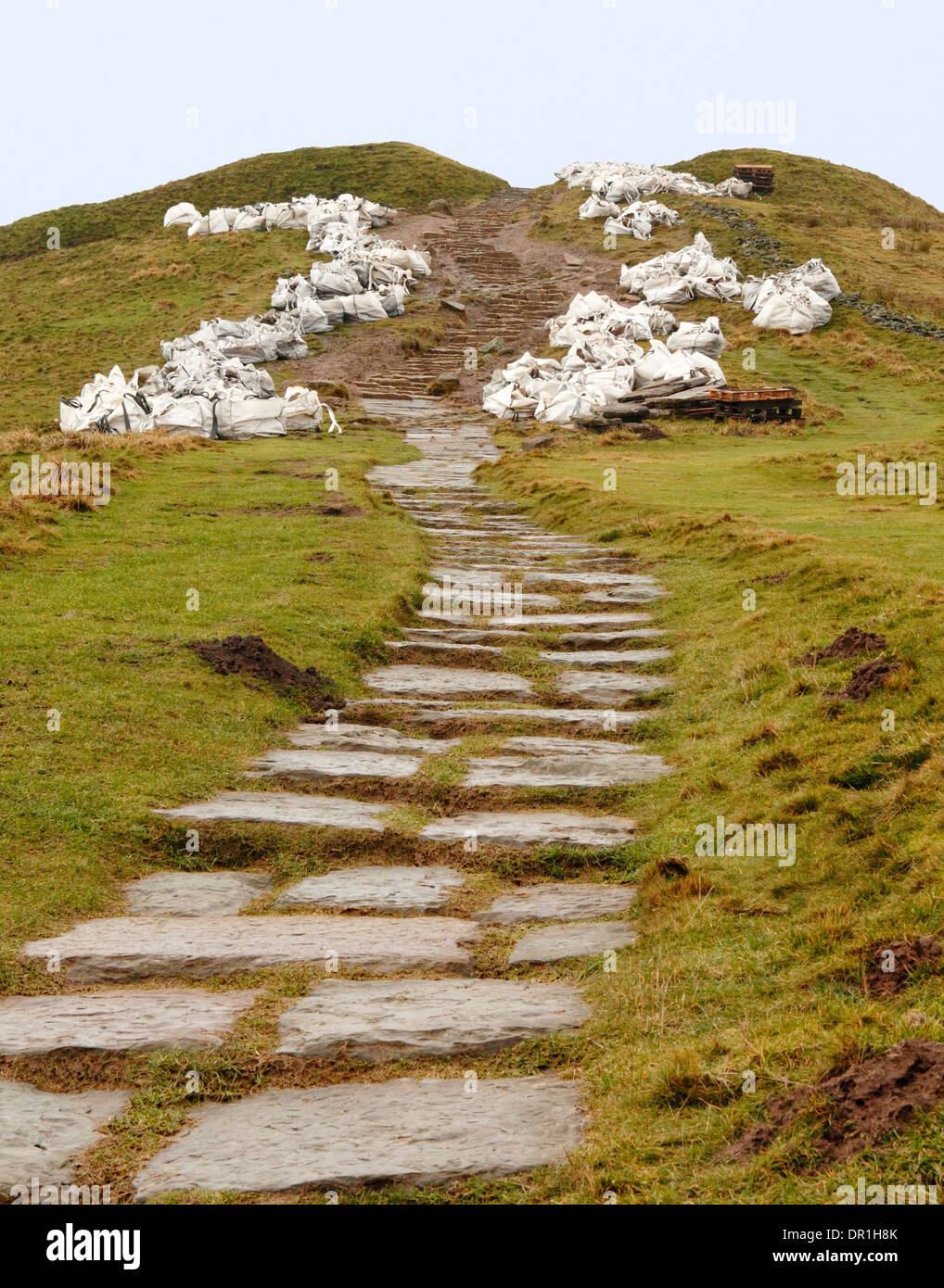 Repair of eroded stone footpath in progress on Mam Tor, a popular walking route near Castleton, Peak District, Derbyshire, UK Stock Photo