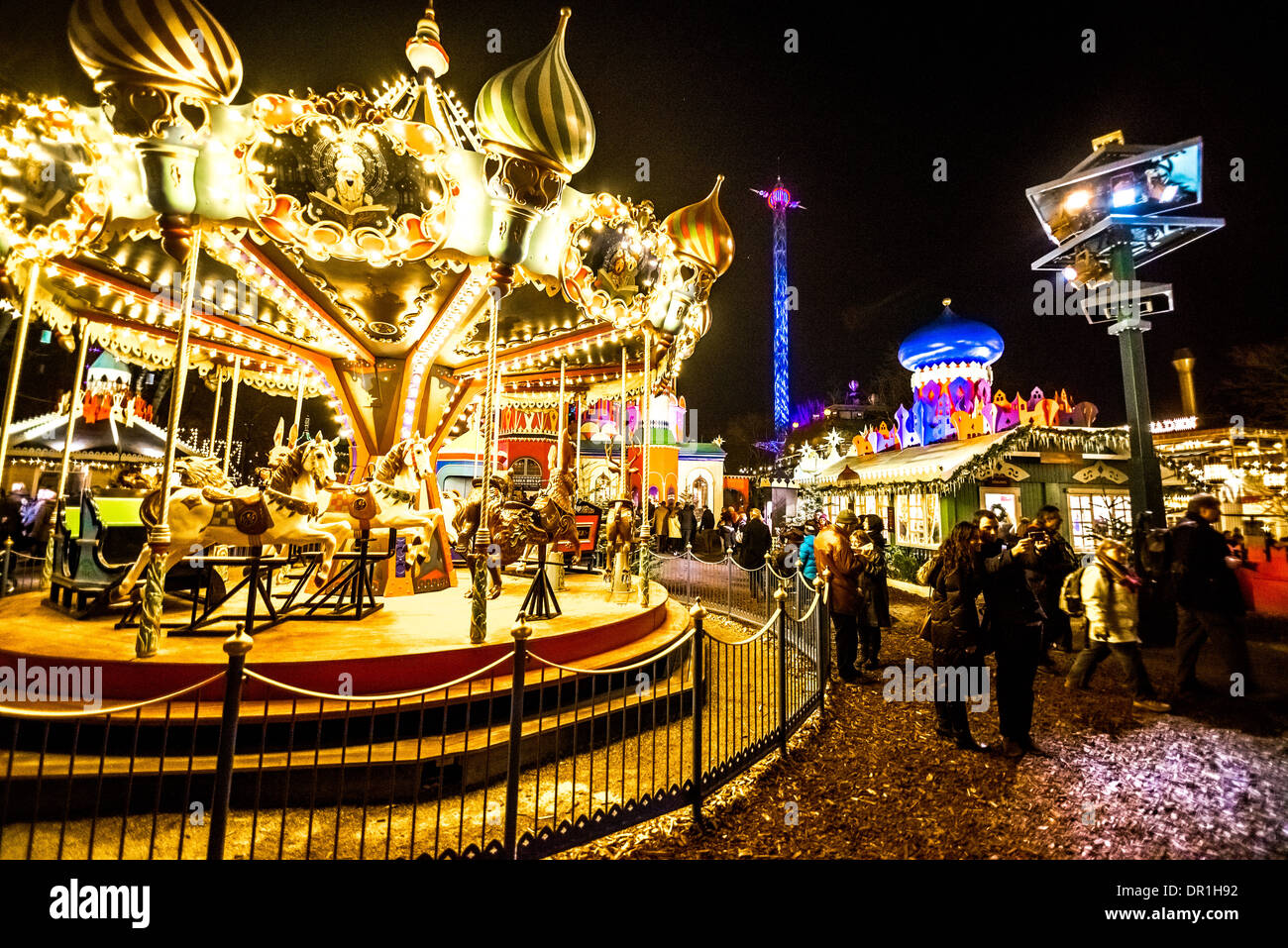 COPENHAGEN - 31 DECEMBER 2013 carousel in Tivoli park in New Eve evening on December 31, 2013 in Copenhagen. Stock Photo