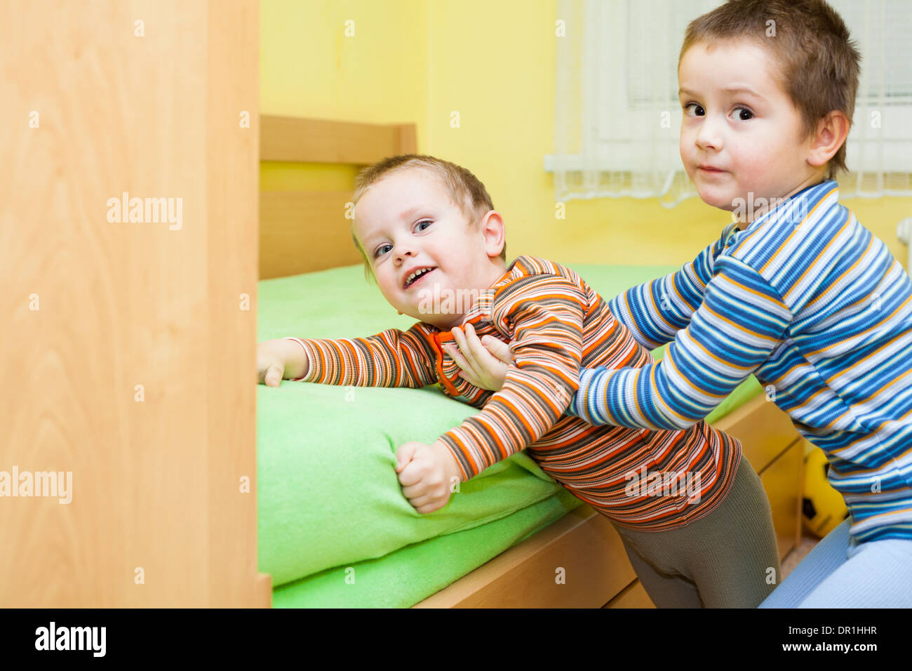 Two children playing together and having fun at home Stock Photo