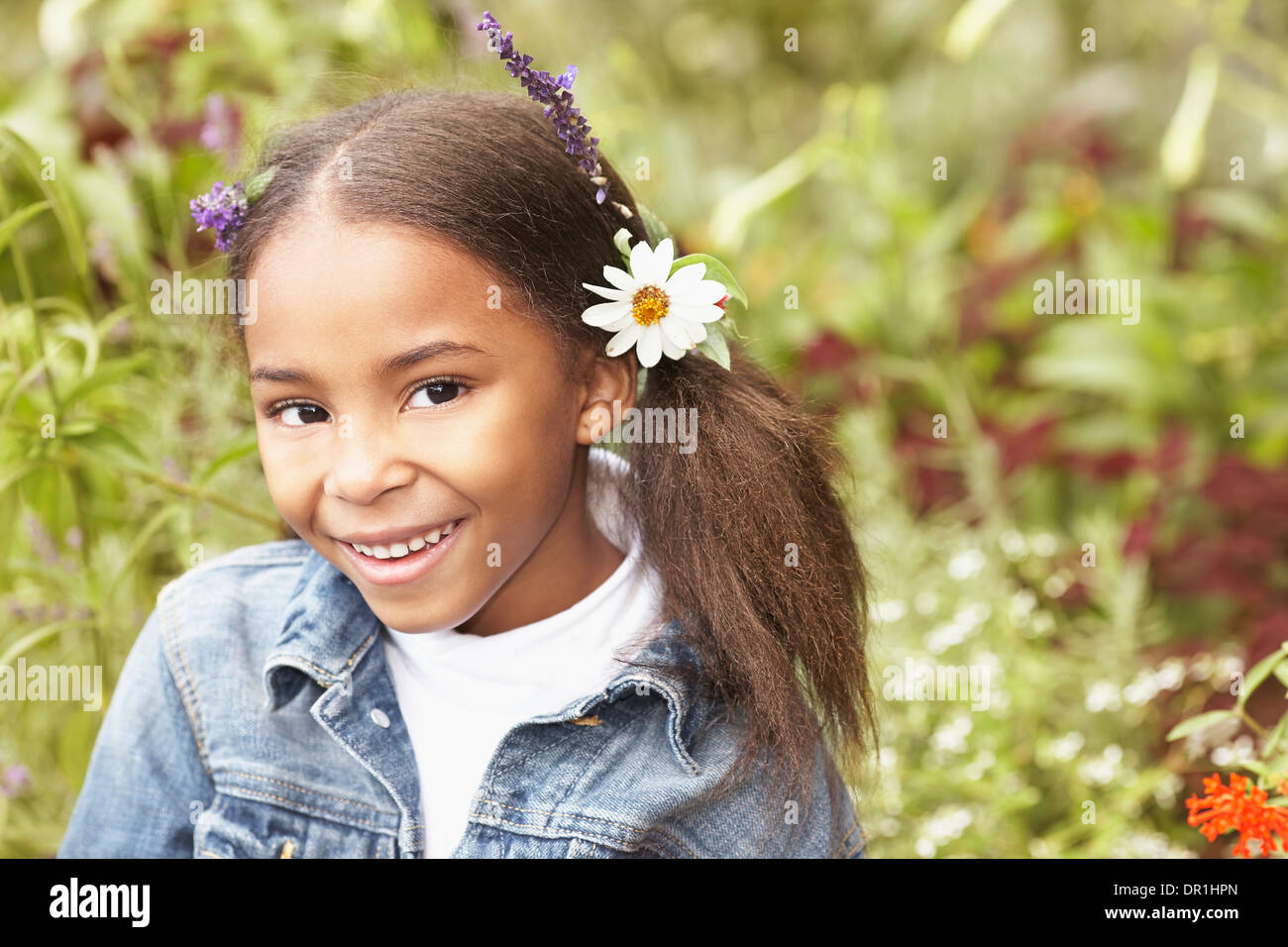 Mixed race girl wearing flowers in her hair Stock Photo Alamy