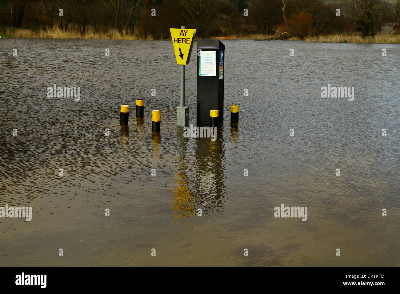 Flooded Car park ticket machine as island Devon Floods Stock Photo