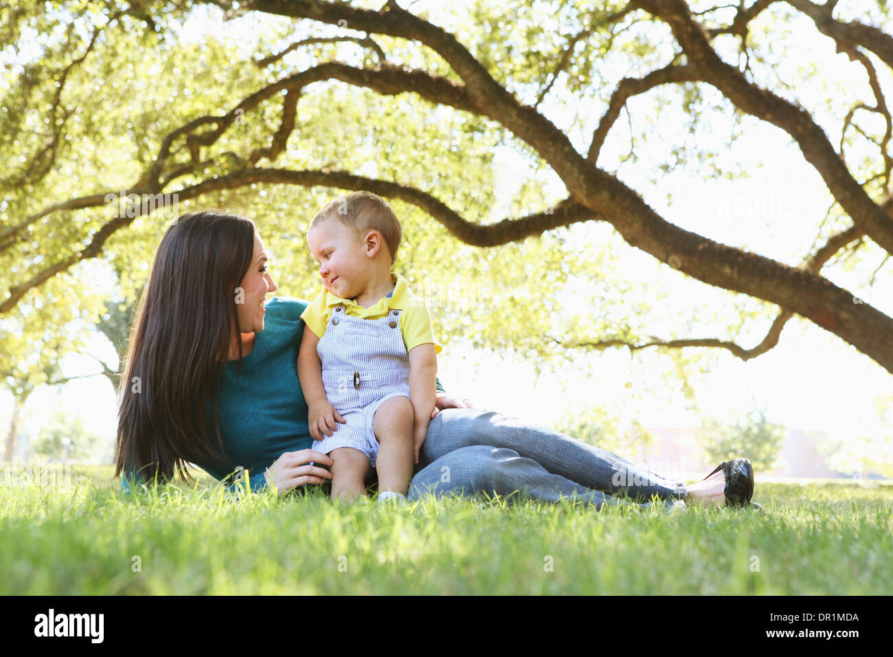 Caucasian mother and son relaxing in park Stock Photo