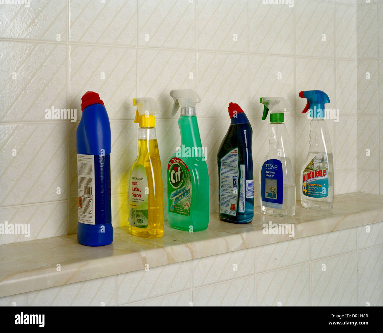 Row of household cleaners on bathroom shelf Stock Photo