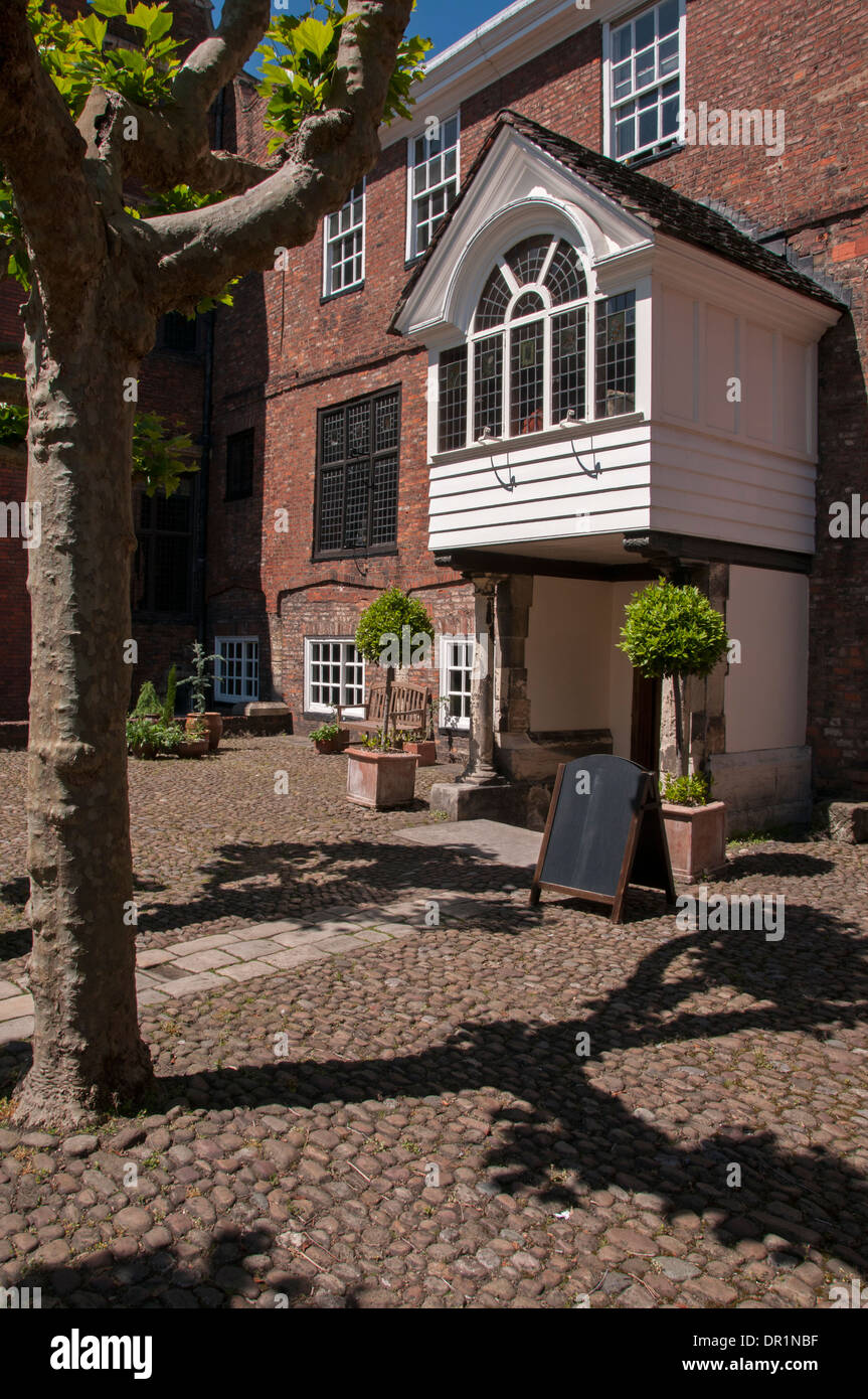 Entrance porch, doorway & cobbled courtyard of historic Grade 1 listed building - Grays Court hotel & restaurant, York, North Yorkshire, England, UK. Stock Photo