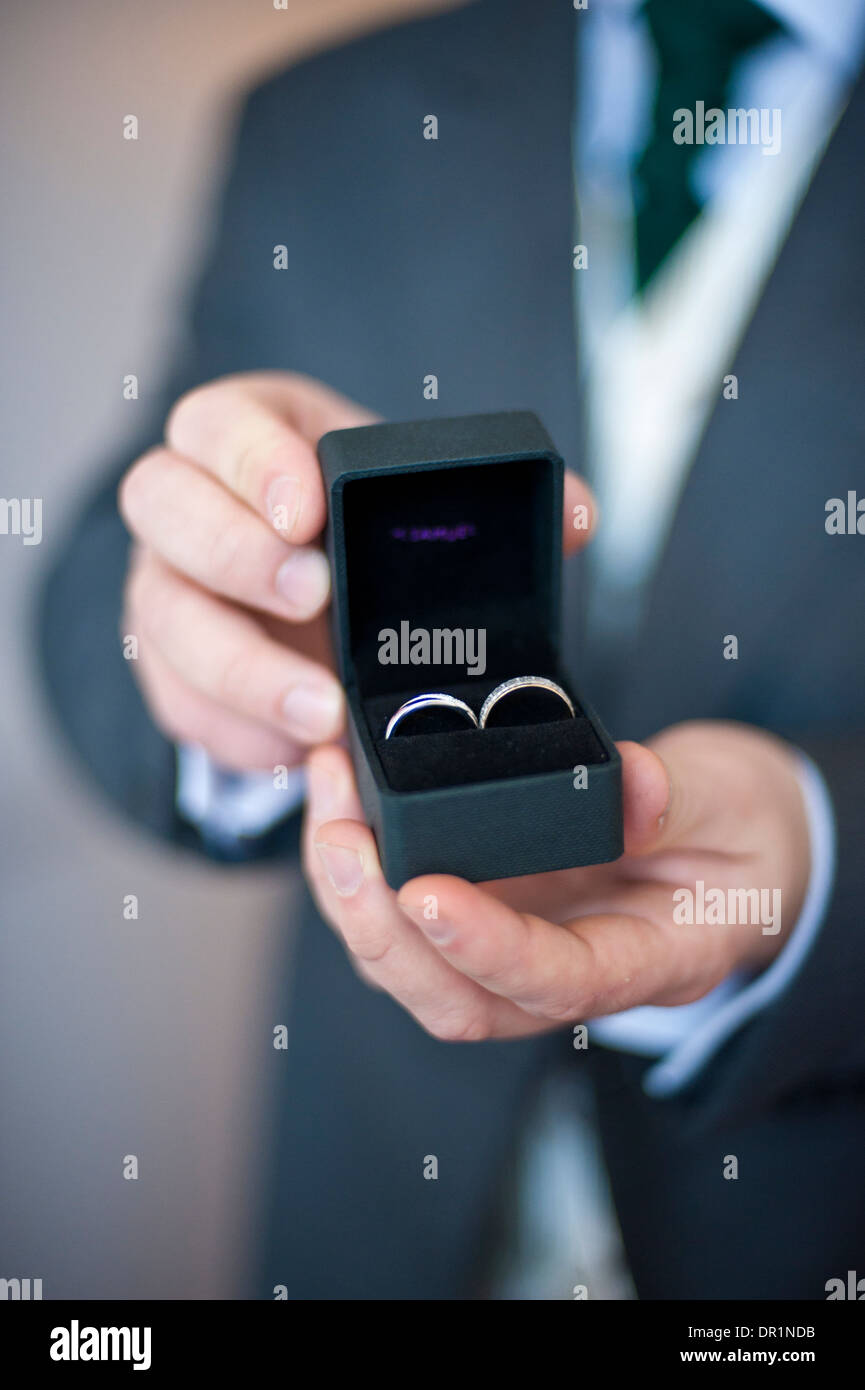 Bride and groom's wedding rings held in hands Stock Photo