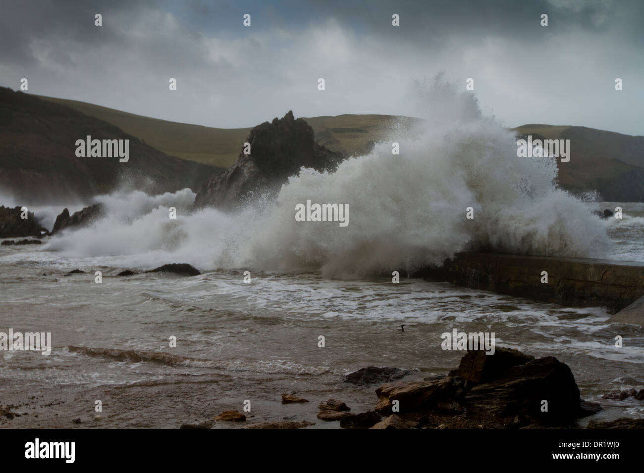 Stormy Seas at Hope cove crashing over sea wall Stock Photo