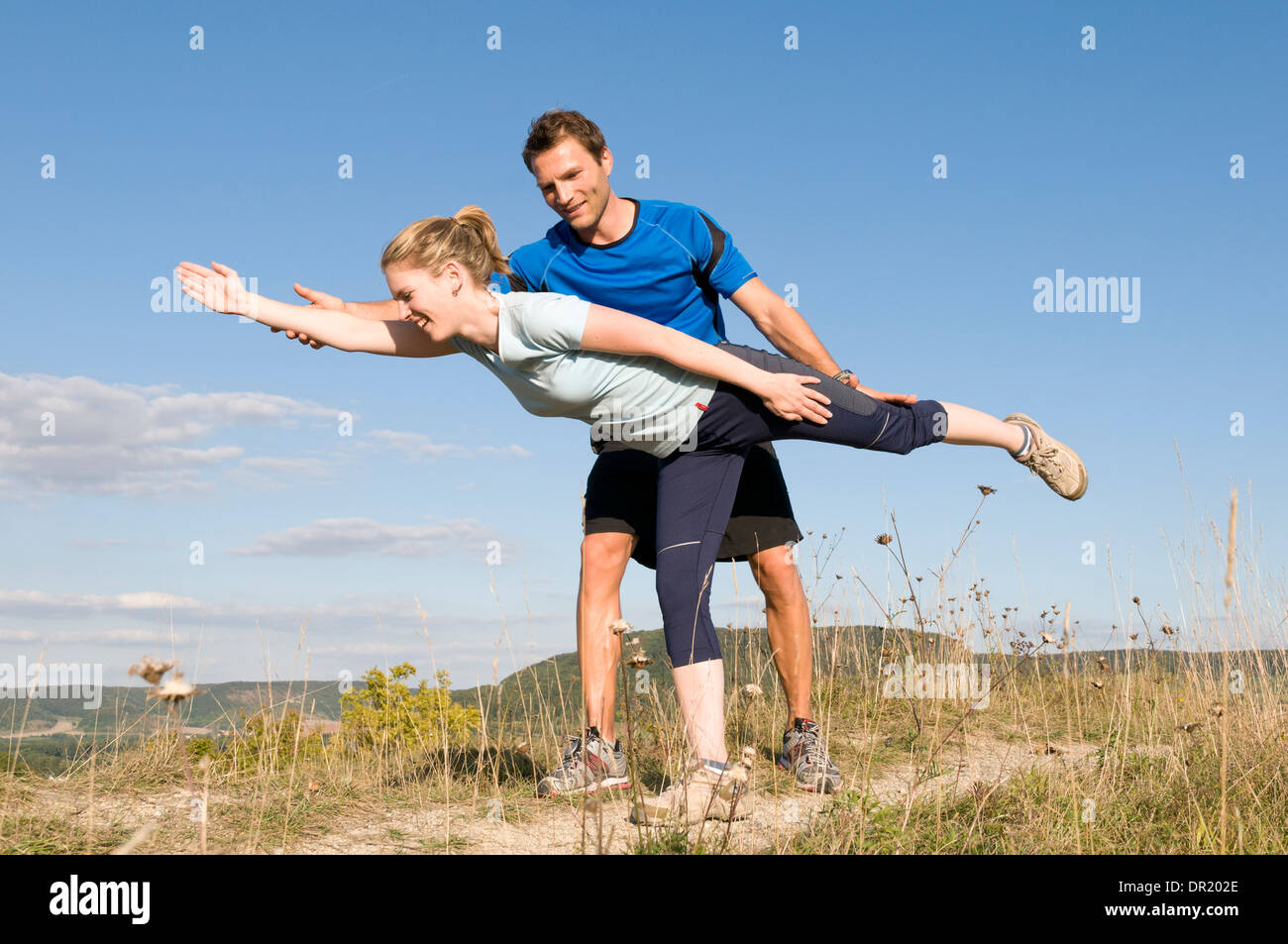 Woman working with personal trainer outdoors Stock Photo